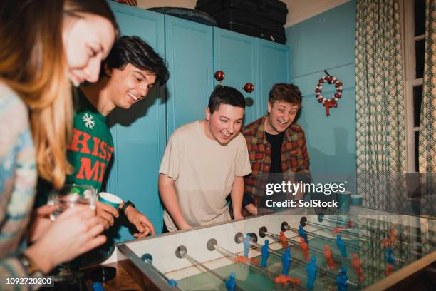 competitive christmas foosball game - flash stock pictures, royalty-free photos & images