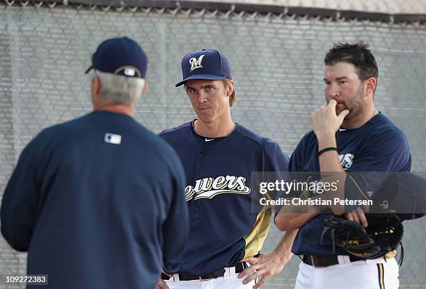 Pitchers Zack Greinke and Shaun Marcum of the Milwaukee Brewers listen to pitching coach Rick Kranitz during a MLB spring training practice at...