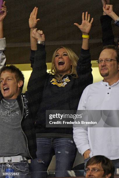 Country singer Carrie Underwood reacts to her husband Mike Fisher of the Nashville Predators scoring a goal against the Vancouver Canucks on February...