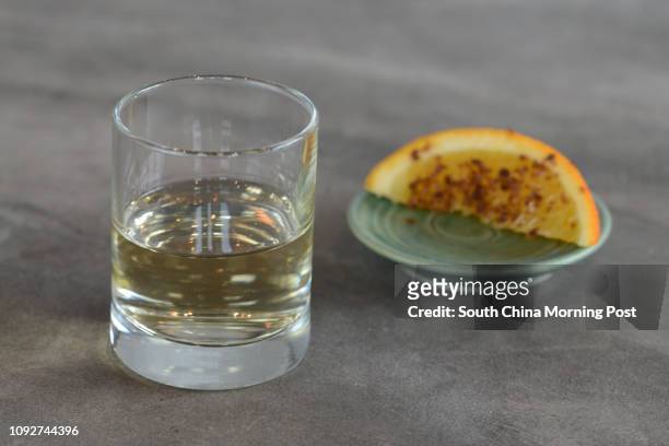 Los Amantes Mezcal Amantes with Agave worm salt on a wedge of orange at Mezcalito, 27fl, 18 On Lan street, Central, Hong Kong on January 19, 2017....