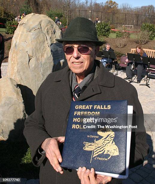 Of 6 fx/memorial, 11/13/04,Larry Morris TWP, #161822 : The man behind the project Pete Hilgartner with the book about those who are honored by the...