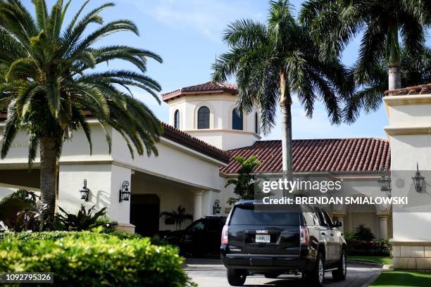 Vehicles belonging to US President Donald Trump's motorcade are seen at the Trump National Golf Club on February 2 in Jupiter, Florida.