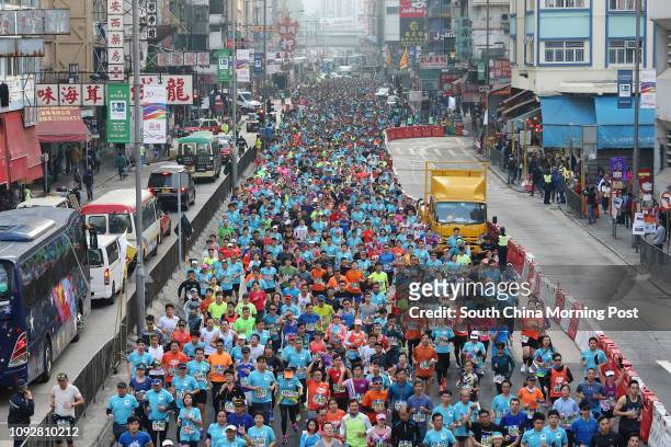 Standard Chartered Hong Kong Marathon runners passing through Mong Kok. 12FEB17 SCMP/ Dickson Lee