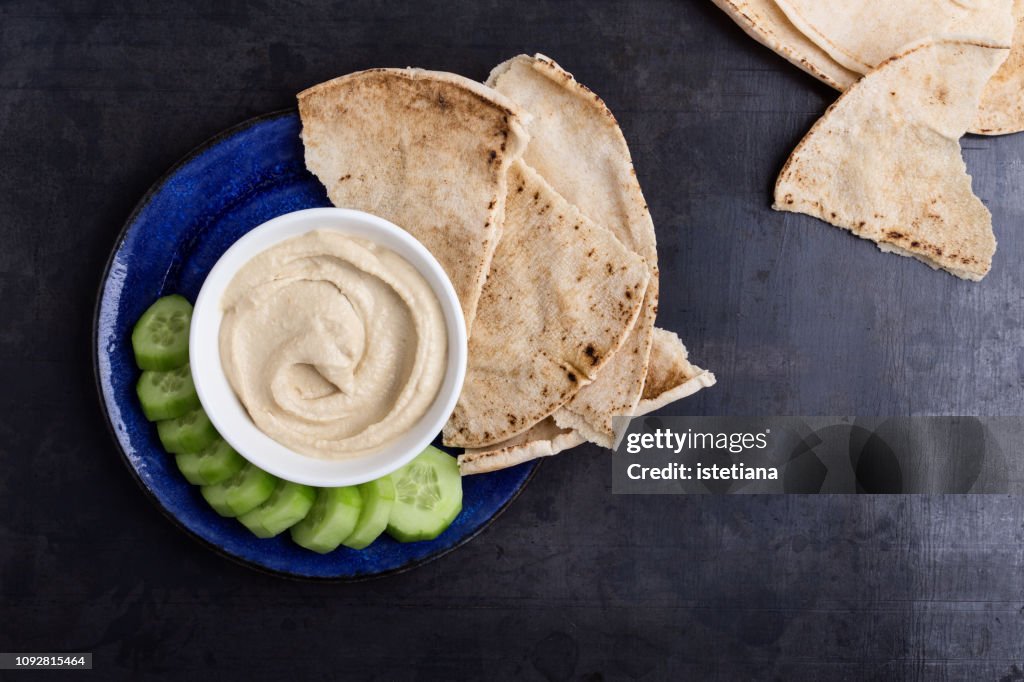 Healthy vegan snack, hummus with pita bread and cucumber
