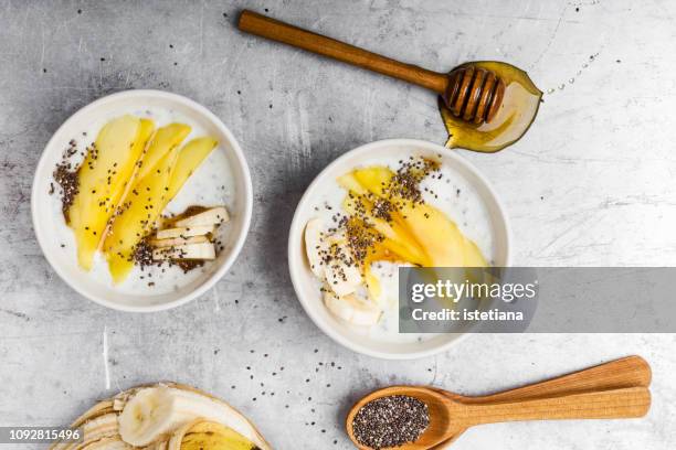 mango banana smoothie bowl - greek yogurt stock pictures, royalty-free photos & images