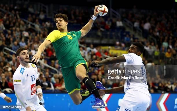 Jose Toledo of Brazil challenges Ludovic Fabregas and Luc Abalo of France during the 26th IHF Men's World Championship group A match between Brazil...