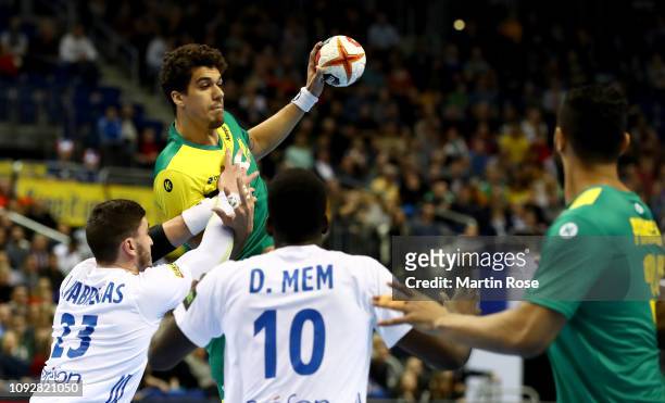 Jose Toledo of Brazil challenges Ludovic Fabregas and Dika Men of France during the 26th IHF Men's World Championship group A match between Brazil...