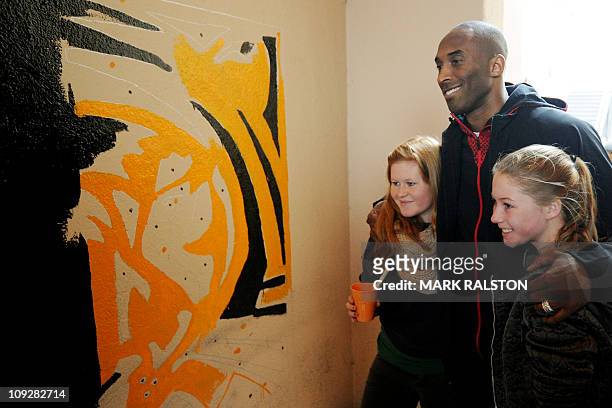 Star Kobe Bryant from the Los Angeles Lakers, poses with students as he participates in the "City Year School Refurbishment Project" at the Virgil...