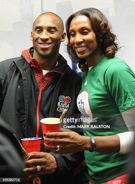 Star Kobe Bryant from the Los Angeles Lakers, is helped by Lisa Leslie from the WNBA as they participate in the "City Year School Refurbishment...