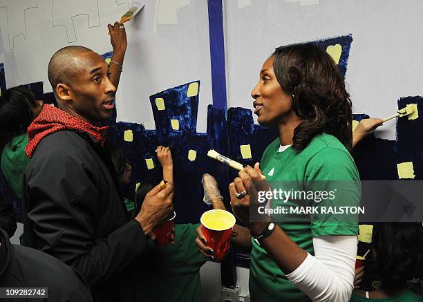 Star Kobe Bryant from the Los Angeles Lakers, is helped by Lisa Leslie from the WNBA as they participate in the "City Year School Refurbishment...