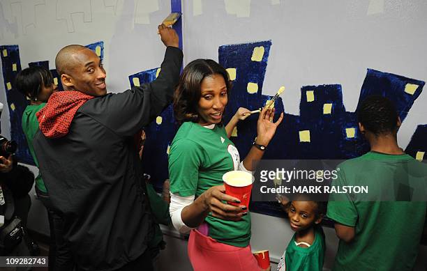 Star Kobe Bryant from the Los Angeles Lakers, is helped by Lisa Leslie from the WNBA as they participate in the "City Year School Refurbishment...