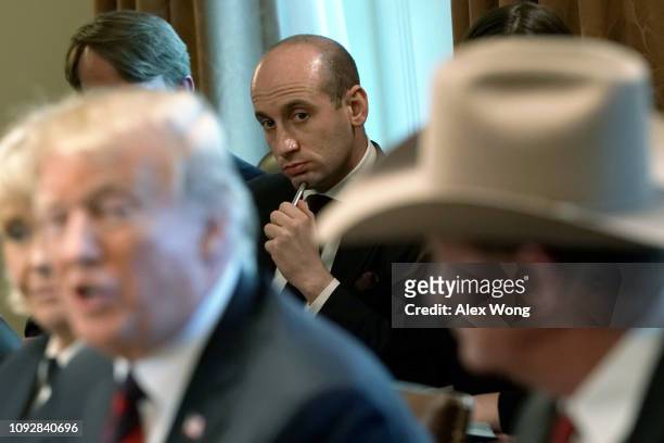 President Donald Trump speaks as Senior Advisor to the President Stephen Miller listens during a round-table discussion on border security and safe...