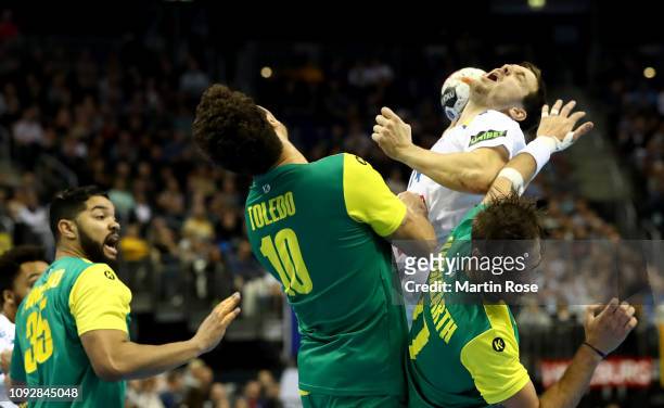 Jose Toledo and Rudolph Hackbarth of Brazil challenges Kentin Mahe of France during the 26th IHF Men's World Championship group A match between...
