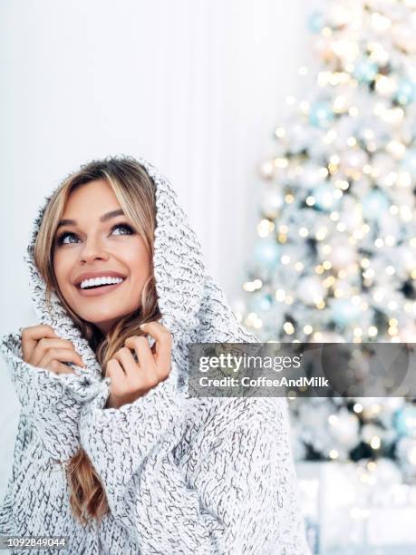 beautiful girl sitting near the christmas tree - hot female models stock pictures, royalty-free photos & images