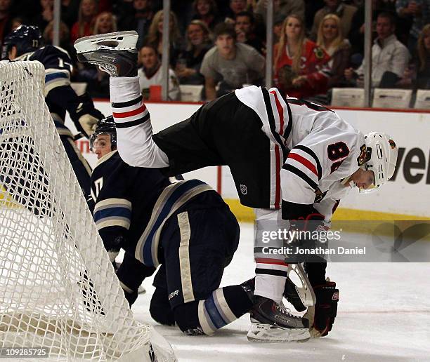 Patrick Kane of the Chicago Blackhawks keeps his balance after colliding with Kris Russell of the Columbus Blue Jackets at the United Center on...