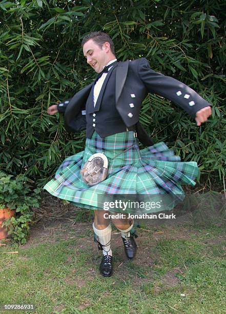 scottish kilt twirl - kilt stock pictures, royalty-free photos & images