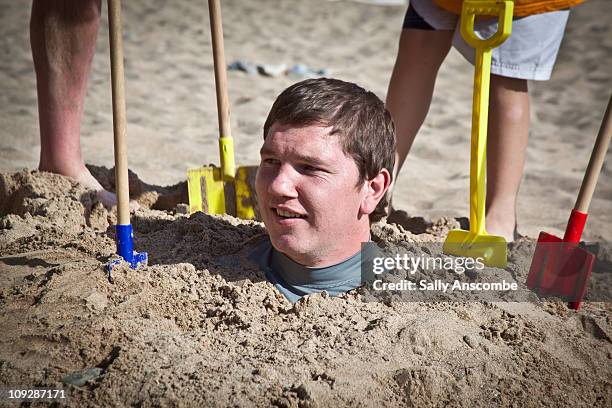 Buried Sand Man Photos and Premium High Res Pictures - Getty Images