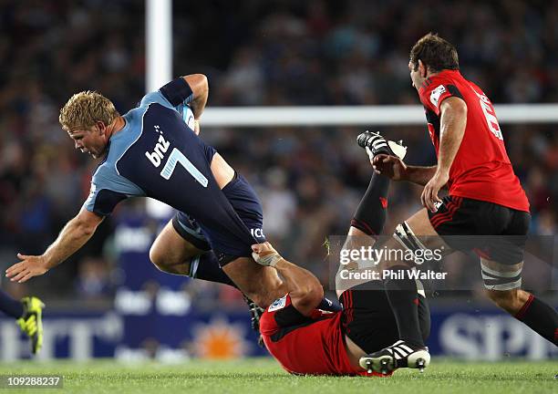 Daniel Braid of the Blues is tackled by Matt Todd of the Crusaders during the round one Super Rugby match between the Blues and the Crusaders at Eden...