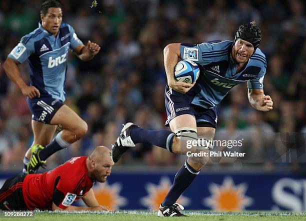 Ali Williams of the Blues runs the ball past the tackle of Ben Franks of the Crusaders during the round one Super Rugby match between the Blues and...