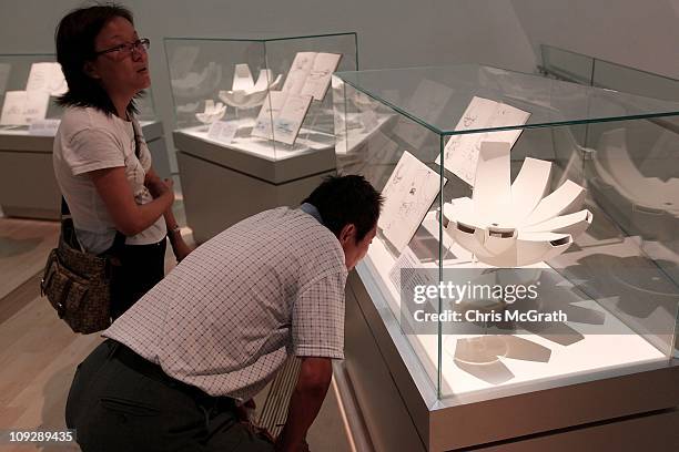 Couple look at a display showing design models for the ArtScience Museum on February 19, 2011 at Marina Bay Sands, Singapore. The ArtScience Museum...