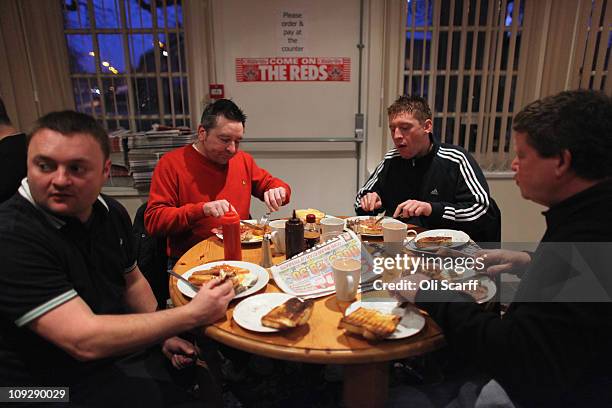 Fans of the non-league football club Crawley Town enjoy breakfast at the Pelham Buckle pub before boarding coaches to Manchester to watch their team...