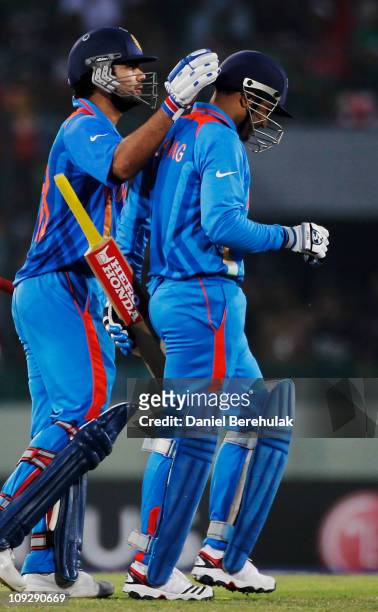 Virender Sehwag of India is congratulated by team mate Virat Kohli after being dismissed for 175 runs during the opening game of the ICC Cricket...