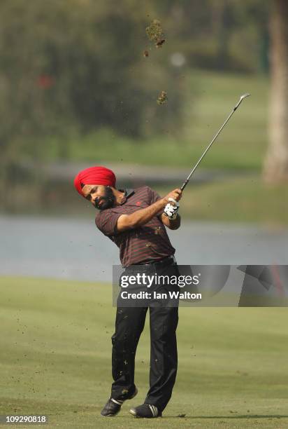 Sujjan Singh of India hits aniron shot during the third round of the Avantha Masters held at The DLF Golf and Country Club on February 19, 2011 in...