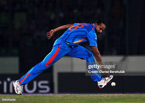 Yusuf Pathan of India fields off his own bowling during the opening game of the ICC Cricket World Cup between Bangladesh and India at the...