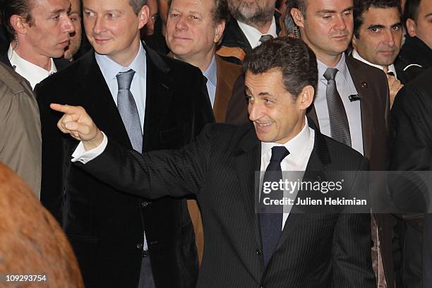 French President Nicolas Sarkozy and French Minister for Agriculture Bruno Lemaire salute the crowd during the inauguration of the ''Salon de...