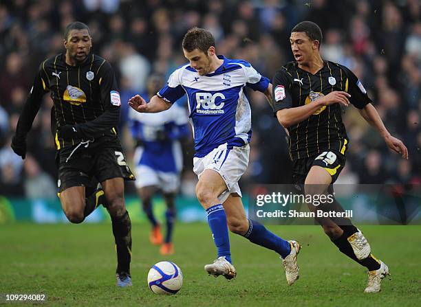 David Bentley of Birmingham City is challenged by Reda Johnson and Liam Palmer of Sheffield Wednesday during the FA Cup Sponsored by e.on 5th Round...