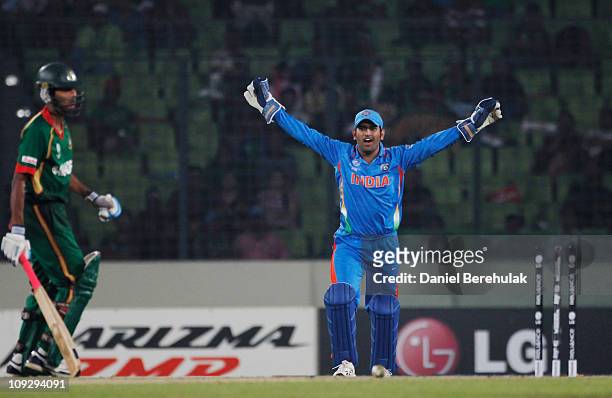 Dhoni celebrates the run out of Shafiul Islam of Bangladesh during the opening game of the ICC Cricket World Cup between Bangladesh and India at the...