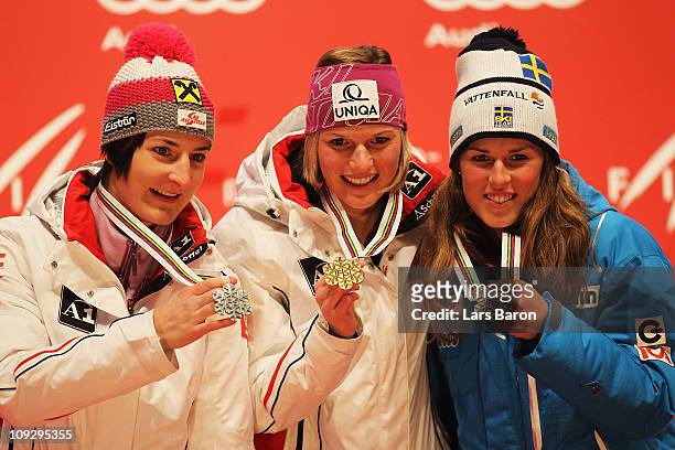 First placed Marlies Schild of Austria, second placed Kathrin Zettel of Austria and third placed Maria Pietilae-Holmner of Sweden celebrate at the...