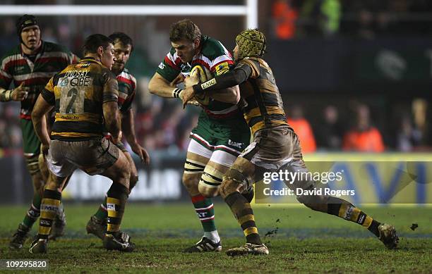 Tom Croft of Leicester is tackled by Richard Birkett during the Aviva Premiership match between Leicester Tigers v London Wasps at Welford Road on...