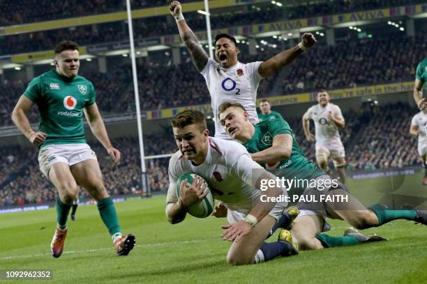 England's centre Henry Slade dives over the line to score a try during the Six Nations international rugby union match between Ireland and England at...