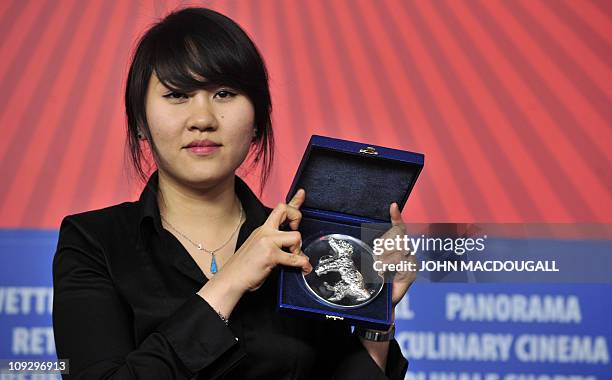 South Korean director Yang Hyo-joo poses with the Silver Bear award of the International Short Film Jury for her film 'The Unbroken' during the...