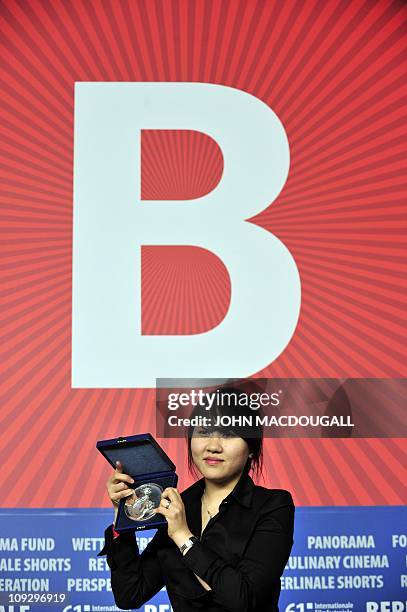 South Korean director Yang Hyo-joo poses with the Silver Bear award of the International Short Film Jury for her film 'The Unbroken' during a press...