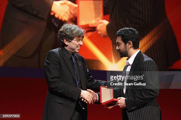German director Andres Veiel receives the Alfred Bauer Award for 'Wer wenn nicht wir' from jury member Aamir Khan at the Award Ceremony during day...