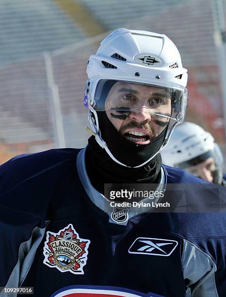 Brian Gionta of the Montreal Canadiens guards against the elements during the practice session the day before the 2011 NHL Heritage Classic at...
