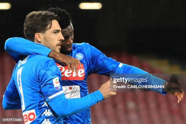 Napoli's Italian midfielder Simone Verdi celebrates with Napoli's Guinean midfielder Amadou Diawara after scoring a penalty during the Italian Serie...