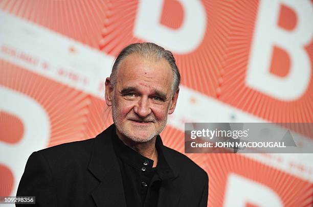 Hungarian director Bela Tarr poses at a press conference after receiving a silver bear in the "JURY GRAND PRIX" for his movie "The Turin Horse" after...