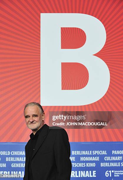 Hungarian director Bela Tarr poses at a press conference after receiving a silver bear in the "JURY GRAND PRIX" for his movie "The Turin Horse" after...