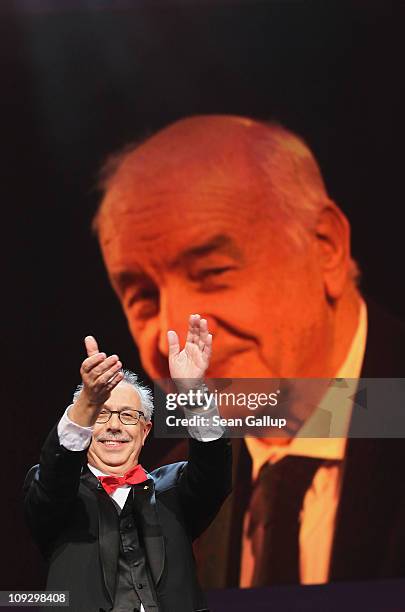 Festival director Dieter Kosslick applauds infront of a picture screen of this years Golden Honory Award winner Armin Mueller-Stahl the Award...