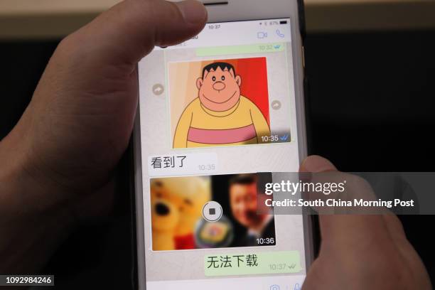 Photo taken of the screen of a smart phone using whatsapp shows a clear image of Japanese cartoon character Takeshi Goda and murky image of Xi...