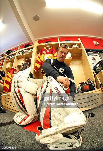 Goaltender Miikka Kiprusoff of the Calgary Flames puts on his leg pads prior to practice for the 2011 Tim Hortons Heritage Classic at McMahon Stadium...