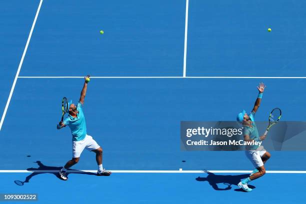 Juan Sebastian Cabal of Columbia and Robert Farah of Colombia warm up prior to the Mens Doubles Final against James Murray of Great Britain and Bruno...