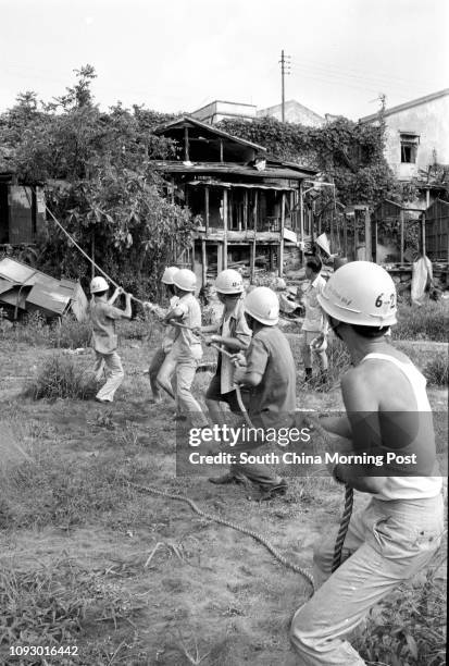 Demolition workers at work in a squatter area in Tsuen Wan. 06SEP78