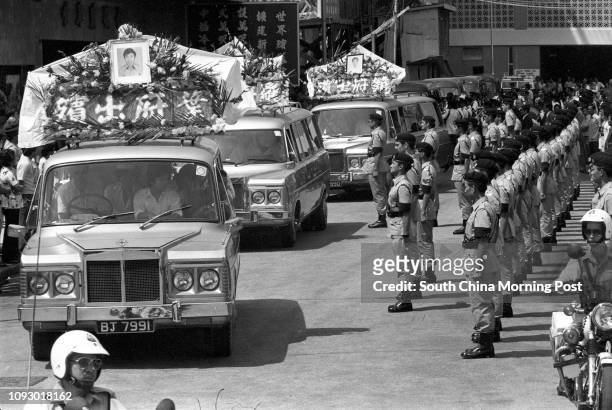 Blue Berets line the funeral route of three police constables killed in a traffic accident. 09OCT78