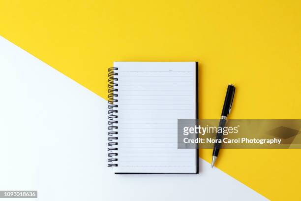 note pad and pen - notepad white table foto e immagini stock