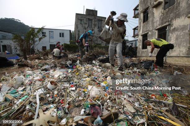 Volunteers cleaning rubbish at the seaside of Shek Tsai Po at Tai O after Typhoon Hato and Severe Tropical Storm Pakhar hit Hong Kong. 30AUG17. SCMP/...