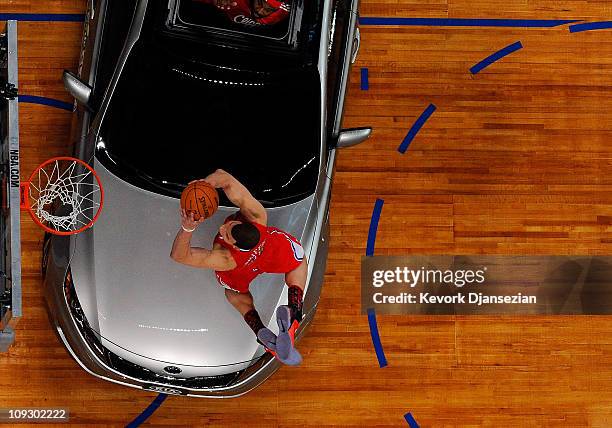 Blake Griffin of the Los Angeles Clippers dunks the ball over a car in the final round of the Sprite Slam Dunk Contest apart of NBA All-Star Saturday...